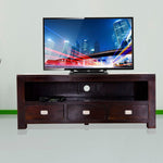 A wooden TV cabinet with drawers, in walnut finish, with a flat-screen TV on top and three drawers with silver handles.