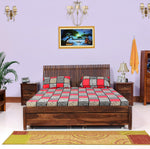 A wooden king-size bed with storage drawers, featuring a brown finish, placed in a bedroom setting with bedding and pillows.