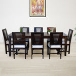 A walnut brown wooden dining table with eight cushioned chairs arranged around it in a dining room setting.