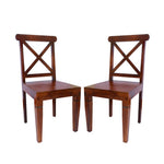 Two solid wood dining chairs with a honey finish, featuring a classic design with crossed backrest slats and a contoured seat.