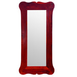 A rectangular decorative wall mirror with a red wooden frame, standing upright.