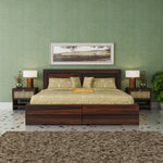 Bedroom with wooden bed, nightstands, and framed picture on a green wall.