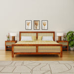 Wooden bed with wicker design in a bedroom setting with lamps and decor.