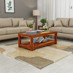 Living room with beige sofas, a wooden coffee table, and decorative items.