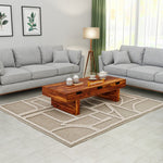 Living room with gray sofas, a wooden coffee table, and decorative elements.