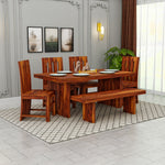 Wooden dining set with table, chairs, and bench in a room with decor elements.