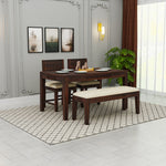 Wooden dining table set with chairs and bench in a room with decor elements.