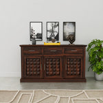 Wooden sideboard with decorative items against a white wall
