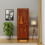 Wooden cabinet in a room with a plant, lamp, and framed picture of the Eiffel Tower.