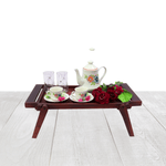 Wooden tray with tea set and flowers on a white background