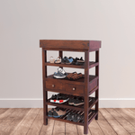 Wooden shoe rack with multiple shelves and drawers against a plain wall.