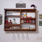 Wall-mounted wooden wine rack with glass holders and shelves, containing wine bottles and glasses, mounted on a white wall under a 'INToxicologist' sign.