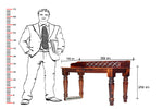 Wooden table with dimensions labeled next to a person in a suit for scale.