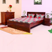 A solid wood king size bed with a brown finish, accompanied by a nightstand and a chest of drawers, also with a matching finish.