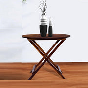 A solid wood folding coffee table in a provincial finish placed on a wooden floor, with decorative vases on top.