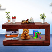 A rectangular solid wood coffee table with a mahogany finish, displayed in a room setting with various items on and around it.