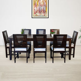 A walnut brown wooden dining table with eight cushioned chairs arranged around it in a dining room setting.