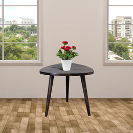 A rectangular wooden stool with a walnut finish, placed on a tiled floor, with a potted plant on top.