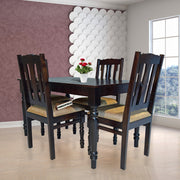 Dining room with a dark wooden table and chairs near a window with a scenic view.
