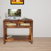 Wooden console table with electronic devices on a wooden floor.