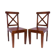 Two solid wood dining chairs with a honey finish, featuring a classic design with crossed backrest slats and a contoured seat.
