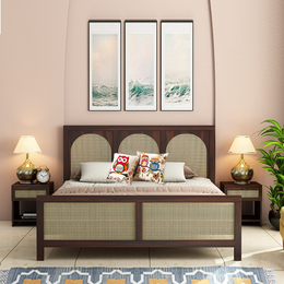 A solid wood king size bed with a walnut finish, accompanied by two matching bedside tables, pillows, and lamps in a room setting.