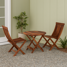 Wooden outdoor table and chairs set against a green wall.