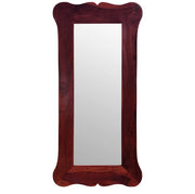 A rectangular wooden frame decorative wall mirror with a carved design on the frame's border.