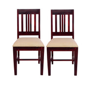 Two solid wood dining chairs with cushions, in a mahogany finish.