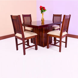 A wooden dining table set with four chairs, the table has a maple finish and the chairs have beige fabric seats. The set is placed against a neutral background.