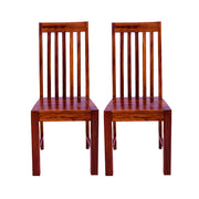 A pair of solid wood high back dining chairs with a teak finish, showcasing a traditional design with vertical slats on the backrest.