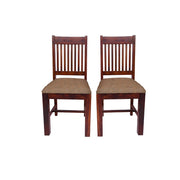 Two solid wood dining chairs with a honey finish and upholstered seats.