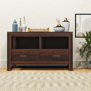 A wooden sideboard cabinet with two drawers and open shelves, placed in a living room setting with decorative items on top.