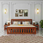 Wooden bed in a bedroom with decorative wall art and lighting.