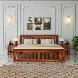 Wooden bed in a bedroom with decorative wall art and lighting.