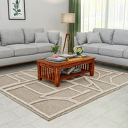 Living room with gray sofas, a wooden coffee table, and a patterned rug.