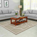 Living room with gray sectional sofas, a wooden coffee table, and decorative elements.