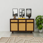 Wooden cabinet with wicker doors in a room with decor elements.