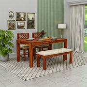 Wooden dining set with table, chairs, and bench in a room with decorative elements.