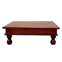 A rectangular wooden pooja chowki with a mahogany finish, featuring carved legs and designed for accommodating god idols.