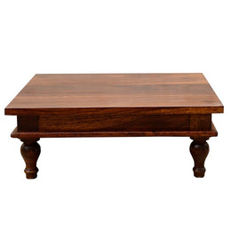Rectangular wooden pooja chowki with teak finish and carved legs on a white background.
