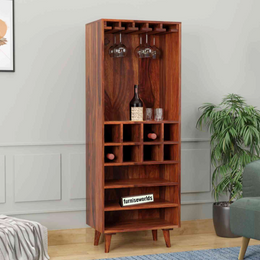 A honey finish solid wood bar cabinet with glass holders on top and wine rack shelves visible.