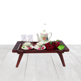 Wooden tray with tea set and flowers on a white background
