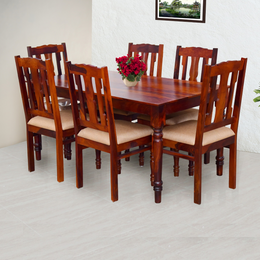 Wooden dining table set with chairs in a room.