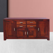 A solid wood sideboard cabinet with a maple finish featuring four doors and four drawers, in a closed state, with metal handles.