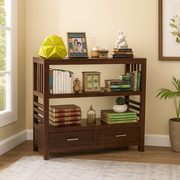 Wooden bookshelf with books, decor items, and a plant in a room with a window.